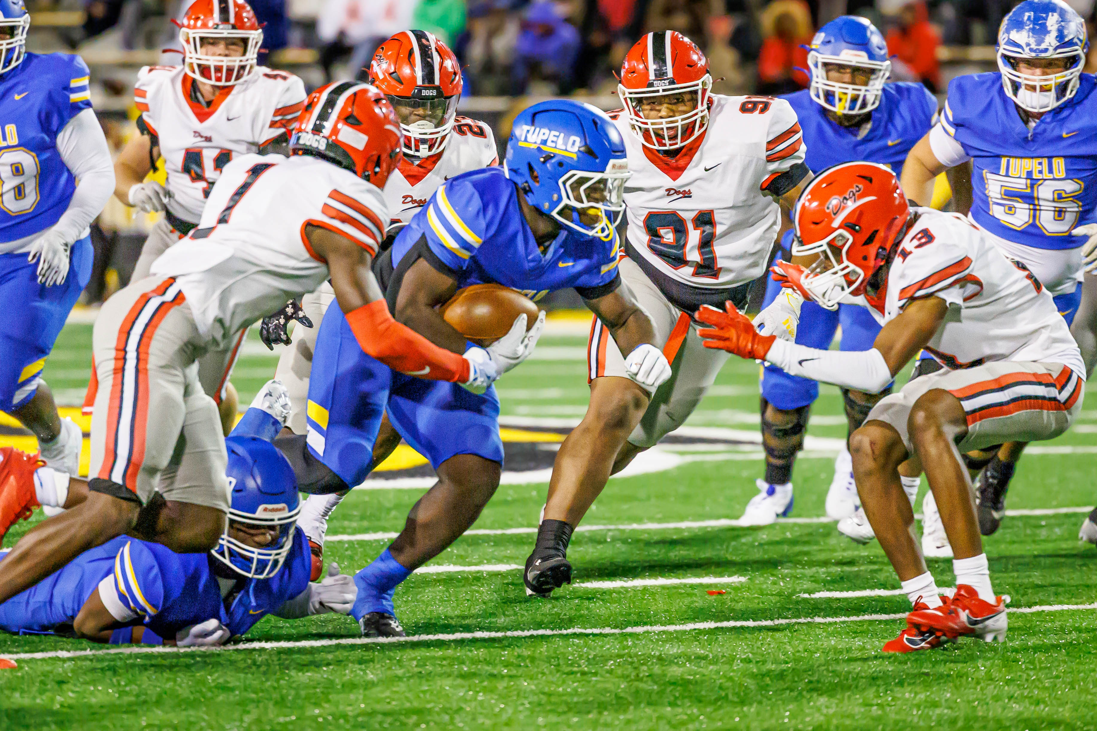 A swarm of Brandon defenders bring down Tupelo's Jaeden Hill.