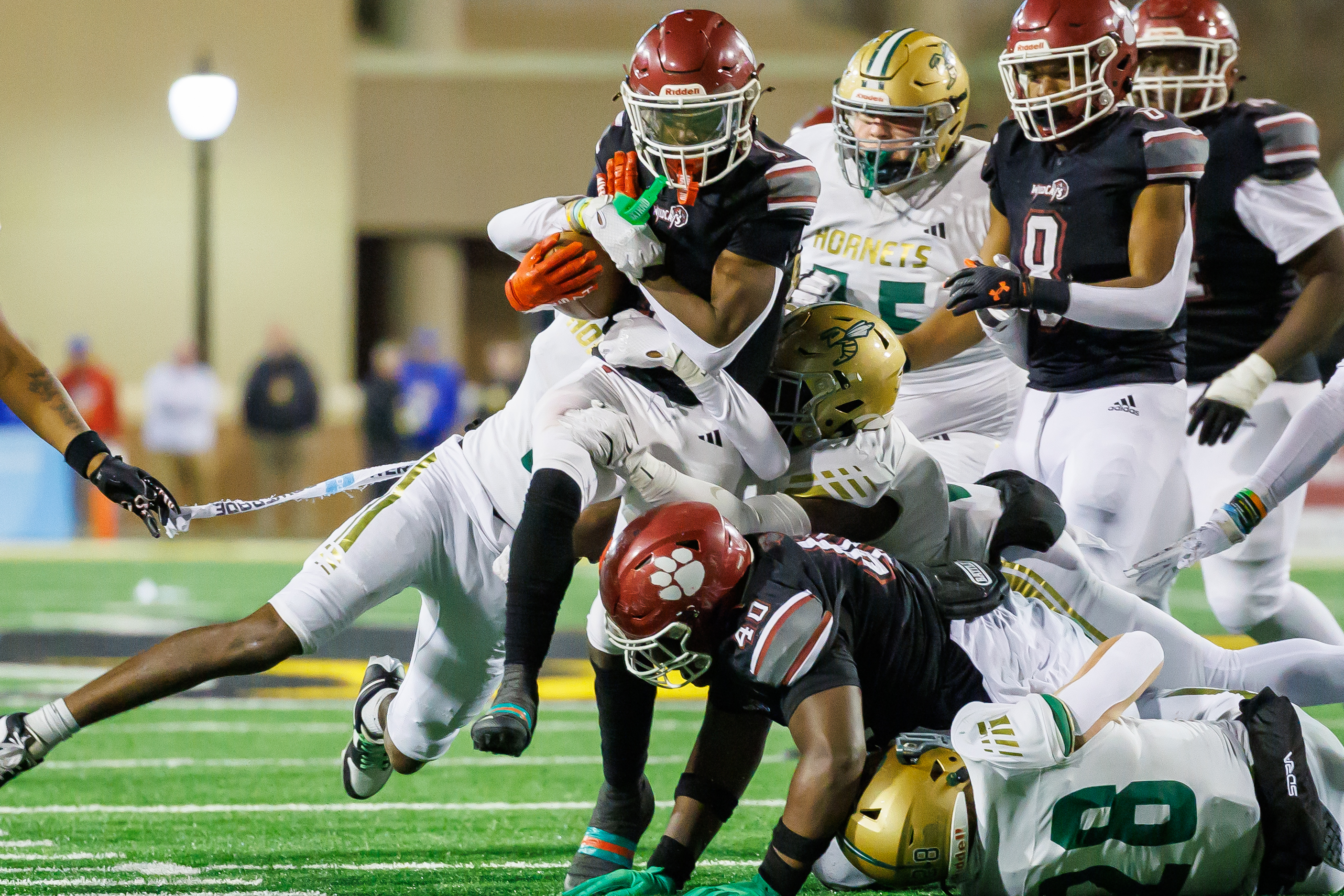 A swarm of Poplarville defenders bring down Jernigan.