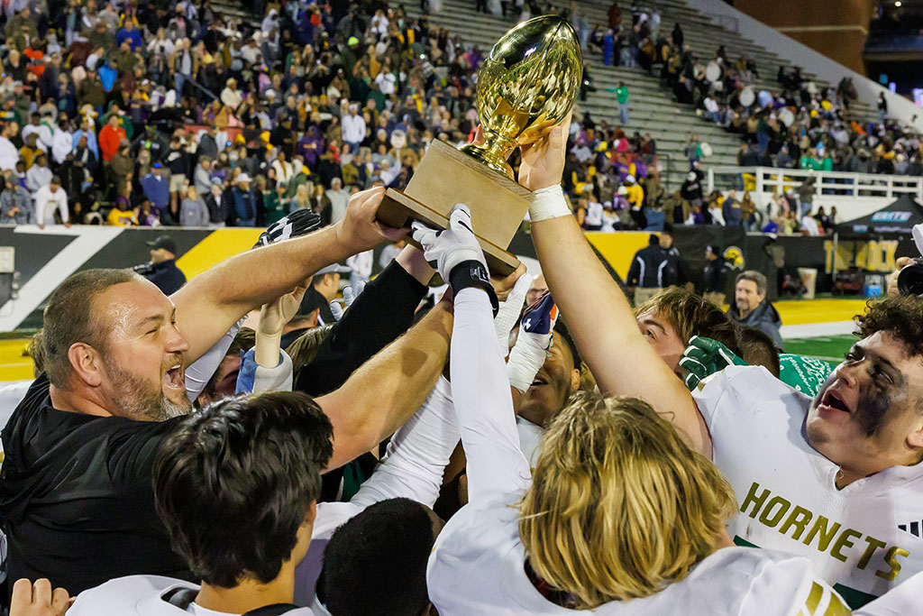 Poplarville celebrates with the championship trophy for the first time in its history.