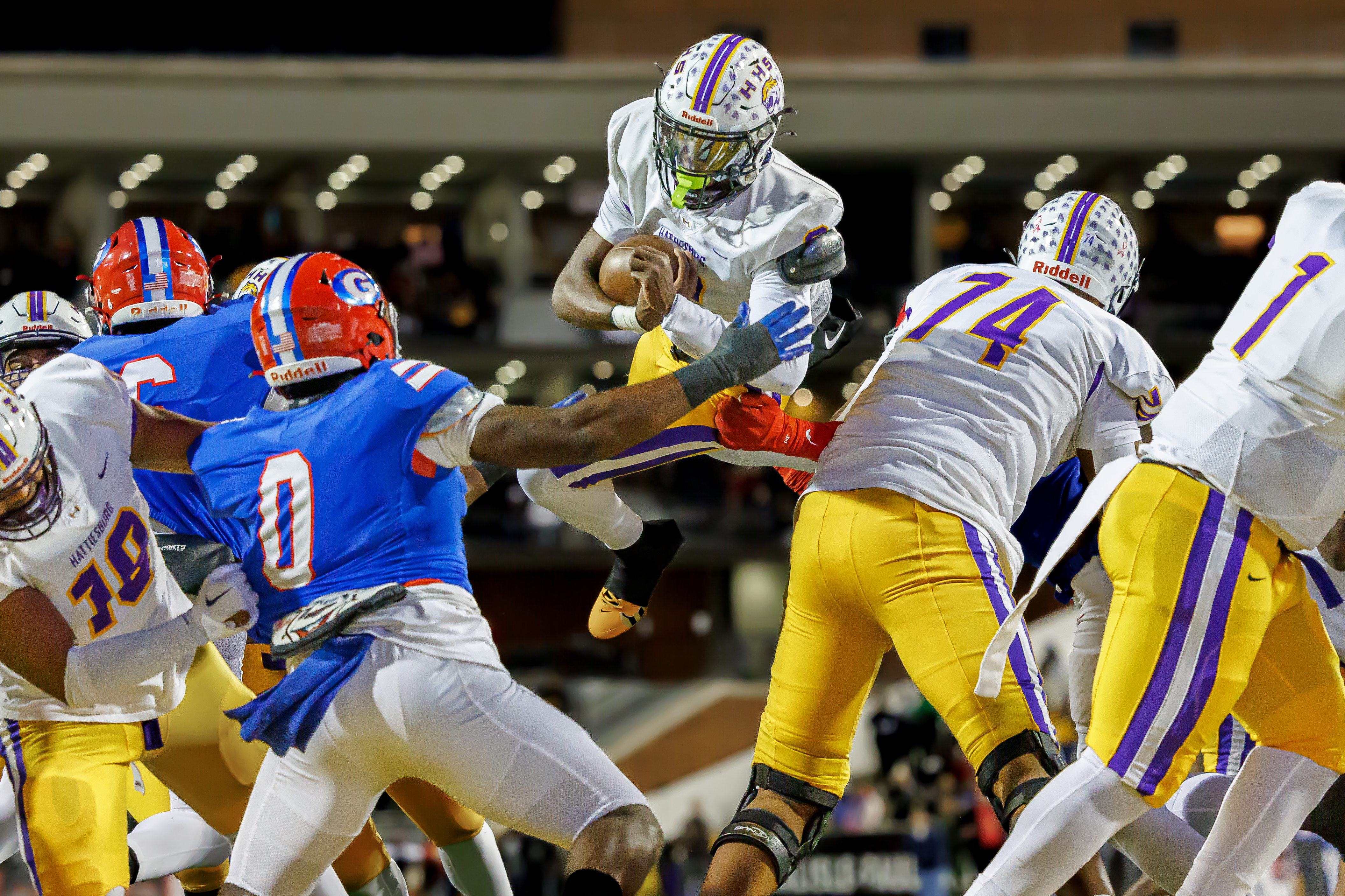 Deuce Vance leaps over the defensive line to score a touchdown.