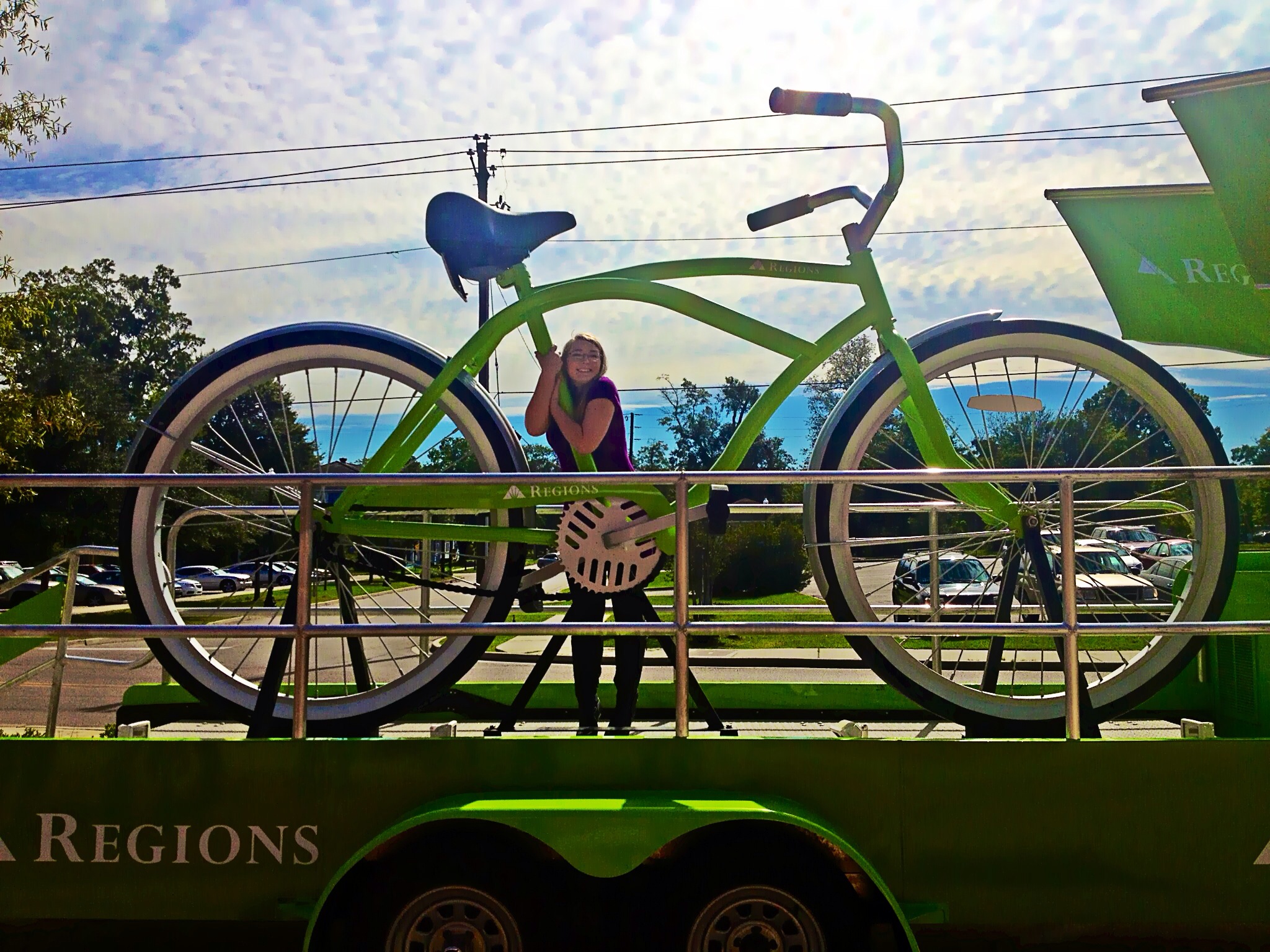 Cayla Camp Burns posing with the infamous gigantic green Regions bicycle in Downtown Hattiesburg, 2013.