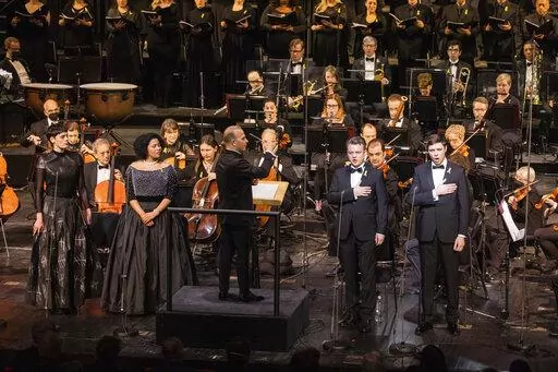 This photo provided by Metropolitan Opera, Met music director Yannick Nézet-Séguin leads mezzo-soprano Emily D’Angelo, soprano Golda Schultz, tenor Dmytro Popov, and bass-baritone Vladyslav Buialskyi in the National Anthem of Ukraine during "For Ukraine: A Concert of Remembrance and Hope" on Friday, Feb. 24, 2023 in New York. (Evan Zimmerman/Metropolitan Opera via AP)