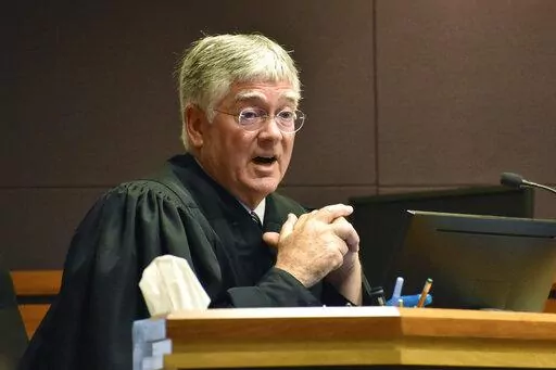 Montana District Judge Michael Moses speaks to attorneys during a court hearing on birth certificate changes for transgender people, on Sept 15, 2022, in Billings, Mont. Moses said in a Monday, Sept. 19, 2022, order that state health officials were being "demonstrably ridiculous" as they repeatedly refused to follow his orders to stop enforcing a state rule that would prevent transgender people from changing the gender on their birth certificate. (AP Photo/Matthew Brown)