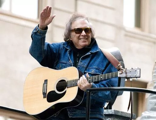 Don McLean rides a float in the Macy's Thanksgiving Day Parade in New York. Feb. 22, 2019. For all those fans of the iconic song "American Pie" who have sometimes wondered about the lyrics they are singing loudly, singer-songwriter Don McLean shares the secrets in the new full-length feature documentary, "The Day the Music Died: The Story of Don McLean's 'American Pie.'". (AP Photo/Charles Sykes, File)