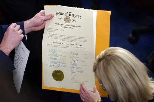 The certification of Electoral College votes for the state of Arizona is unsealed during a joint session of the House and Senate convenes to confirm the electoral votes cast in November's election, at the Capitol, Jan 6, 2021. Members of Congress have officially objected to the results in four of the last six presidential elections, a partisan practice that has been legal for over a century but became much more fraught after a violent mob of former President Donald Trump’s supporters attacked 