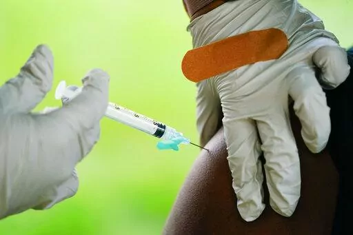 A health worker administers a dose of COVID-19 vaccine during a vaccination clinic in Reading, Pa. COVID-19 vaccinations are at a critical juncture as companies test whether new approaches like combination shots or nasal drops can keep up with a mutating coronavirus — even though it’s not clear if any change is needed. (AP Photo/Matt Rourke, File)