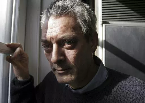 Writer Paul Auster poses at his home in the Brooklyn borough of New York, Jan. 19, 2006. Paul Auster, a prolific, prize-winning man of letters and filmmaker known for such inventive narratives and meta-narratives as “The New York Trilogy” and “4 3 2 1,” has died at age 77. (AP Photo/Bebeto Matthews, File)