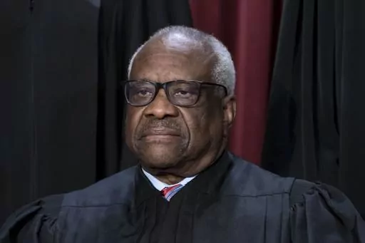 Associate Justice Clarence Thomas joins other members of the Supreme Court as they pose for a new group portrait, at the Supreme Court building in Washington, Oct. 7, 2022. Thomas is acknowledging that he took three trips last year aboard a private plane owned by Republican megadonor Harlan Crow. It’s the first time in years that Thomas has reported receiving hospitality from Crow. (AP Photo/J. Scott Applewhite, File)