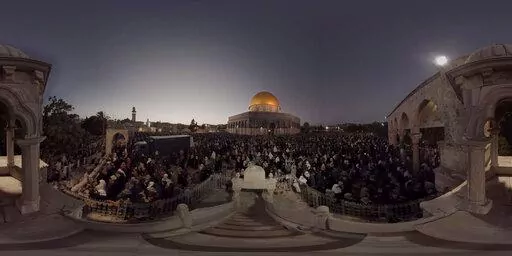 This July 22, 2019, photo taken from video gives a 360-degree view of Ramadan prayers on the plateau of the Dome of the Rock, which can be seen in The Holy City, a virtual reality experience in the metaverse. (The Holy City VR via AP)
