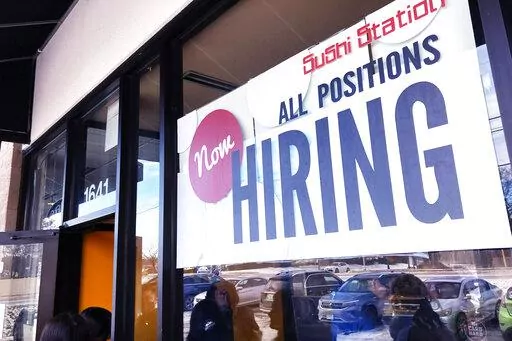 A hiring sign is displayed at a restaurant in Rolling Meadows, Ill., Tuesday, Dec. 27, 2022. (AP Photo/Nam Y. Huh)