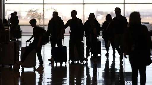 People pass through Salt Lake City International Airport on Wednesday, Jan. 11, 2023, in Salt Lake City. Thirty percent of Americans don't identify with a religious group — but not all of them are atheists or agnostics. In fact, 43% of the group known as the "nones" say they believe in God, even if they largely dislike organized religion. (AP Photo/Rick Bowmer, File)