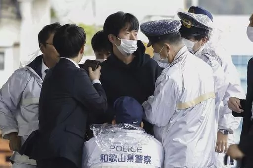 A man who was later identified as Ryuji Kimura is arrested after what appeared to be a pipe bomb was thrown at Japanese Prime Minister Fumio Kishida during his visit at a port in Wakayama, western Japan, Saturday, April 15, 2023. Kimura, who allegedly threw a pipe bomb at Kishida at a campaign venue, has complained about Japan’s election system and filed a damages suit against the government and criticized the prime minister, according to media reports and his possible social media postings. (
