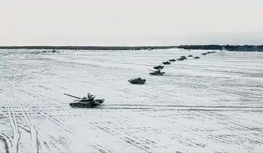 In this photo taken from video and released by the Russian Defense Ministry Press Service on Friday, Feb. 4, 2022, tanks and armored vehicles move during the Belarusian and Russian joint military drills at Brestsky firing range, Belarus. With Russia carrying out a massive military buildup near Ukraine and the West roundly rejecting Moscow’s security demands, a window for diplomacy in the crisis appears to be closing. But even as Moscow continues to bolster its forces and holds sweeping war gam