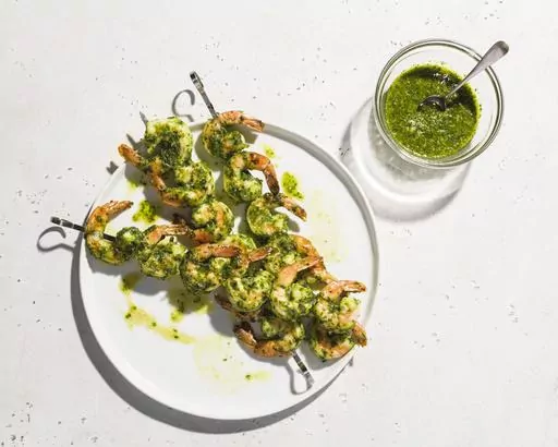 This image released by Milk Street shows a recipe for broiled shrimp with garlic, lemon and herbs, (Milk Street via AP)