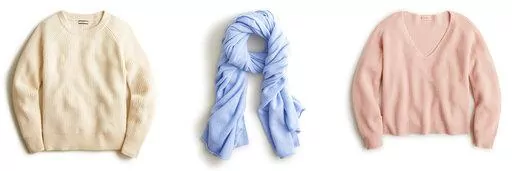 This combination of photos shows a ribbed cashmere crewneck sweater, left, a cashmere wrap, center, and ribbed cashmere V-neck sweater from J.Crew. (J.Crew via AP)