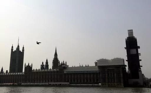 Britain's Houses of Parliament, covered in hoarding and scaffolding as it undergoes restoration work to repair the crumbling building, in London, Wednesday, April 17, 2019. British lawmakers are warning that the country's Parliament building is at “real and rising” risk of destruction. The House of Commons Public Accounts Committee said Parliament is “leaking, dropping masonry and at constant risk of fire,” as well as riddled with asbestos. The committee said Wednesday, May 17, 2023 that
