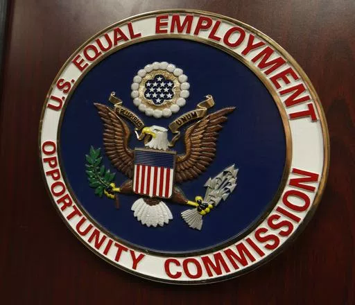 The emblem of the U.S. Equal Employment Opportunity Commission is shown on a podium in Vail, Colo., Tuesday, Feb. 16, 2016, in Denver. Pregnant workers have the right to a wide range of accommodations under new federal regulations for implementing the Pregnant Workers Fairness Act. The regulations take an expansive view of conditions related to pregnancy, from fertility treatments to abortion and post-childbirth complications. (AP Photo/David Zalubowski, File)