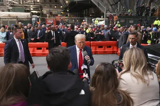 Former President Donald Trump speaks members of the media while visiting with construction workers at the construction site of the new JPMorgan Chase headquarters in midtown Manhattan, Thursday, April 25, 2024, in New York. Trump met with construction workers and union representatives hours before he's set to appear in court. (AP Photo/Yuki Iwamura, File)