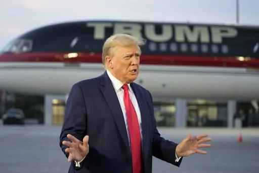 Former President Donald Trump speaks with reporters before departure from Hartsfield-Jackson Atlanta International Airport, Aug. 24, 2023, in Atlanta. A liberal group has filed a lawsuit to bar Trump from the primary ballot in Colorado. The lawsuit contends Trump is ineligible to run for the White House again under a rarely used clause in the U.S. Constitution aimed at candidates who have supported an “insurrection.” (AP Photo/Alex Brandon, File)