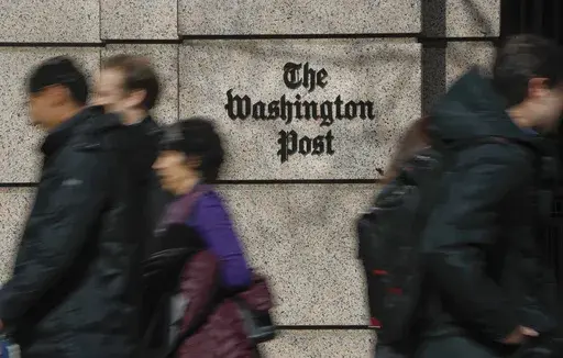 People walk by the One Franklin Square Building, home of The Washington Post newspaper, in downtown Washington, Feb. 21, 2019. The struggling Washington Post was in some turmoil on Monday, June 3, 2024, following a hastily announced restructuring plan aimed at stopping an exodus of readers over the past few years, and the departure of the newspaper's executive editor, Sally Buzbee. (AP Photo/Pablo Martinez Monsivais, File)