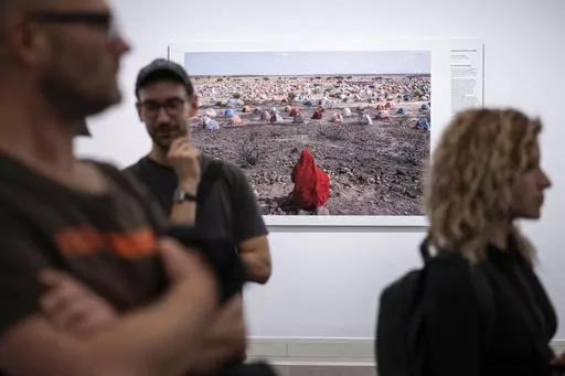 Jonathan Fointaine's "The Nomad's Final Journey", which was awarded with an honorable mention by the World Press Photo jury, is on display at the opening of the World Press Photo 2023 exhibition at the Hungarian National Museum, in Budapest, Hungary, Thursday, Sept. 21, 2023. Minors under 18 have been barred from visiting this year’s World Press Photo exhibition in Hungary after the government determined that some of its photos violate a contentious law restricting LGBTQ+ content. (Szigetvary 