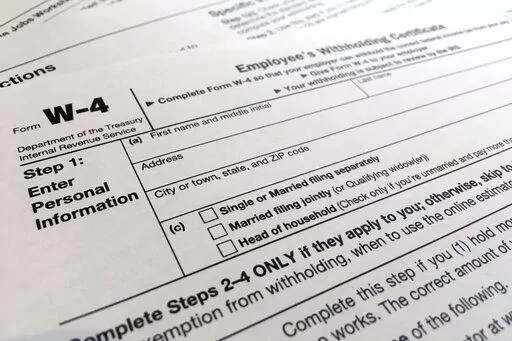 A W-4 form on Feb. 5, 2020, in New York. Monday is Tax Day, the federal deadline for individual tax filing and payments. The IRS will receive tens of millions of filings electronically and through paper forms. (AP Photo/Patrick Sison, File)