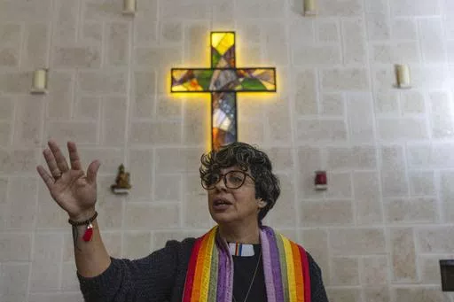 Rev. Elaine Saralegui, wearing a rainbow-colored clergy stole and her clerical collar, leads a service at the Metropolitan Community Church, an LGBTQ+ inclusive house of worship, in Matanzas, Cuba, Friday, Feb. 2, 2024. In recent years, the communist-run island barred anti-gay discrimination, and a 2022 government-backed “family law” — approved by popular vote — allowed same-sex couples the right to marry and adopt. (AP Photo/Ramon Espinosa) (AP Photo/Ramon Espinosa)