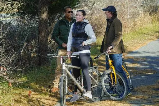 Naomi Biden, second from left, and her fiancé Peter Neal, right, stop on bikes in Nantucket, Mass., Nov. 25, 2021, for President Joe Biden and first lady Jill Biden to pass in a motorcade. Naomi Biden, the daughter of President Joe Biden's son Hunter, is planning to celebrate her wedding at the White House on Nov. 19. Naomi Biden tweeted that she is "endlessly grateful" to her "Nana and Pop" for the opportunity to celebrate her wedding at the White House."(AP Photo/Carolyn Kaster, File)