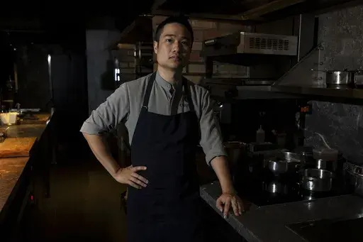 Quang Dung, the chef and owner of Chapter Dining, poses for a photo on March 1, 2025, in Hanoi, Vietnam. (AP Photo/Yannick Peterhans)