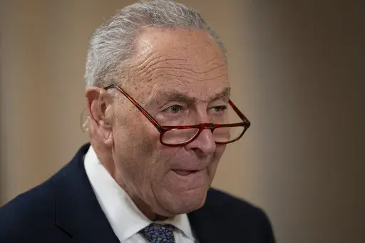 Senate Minority Leader Chuck Schumer, D-N.Y., gives a television interview, as the Senate works to avert a partial government shutdown ahead of the midnight deadline, at the Capitol in Washington, Friday, March 14, 2025. (AP Photo/Ben Curtis)