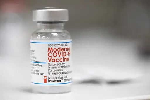 A vial of the Moderna COVID-19 vaccine is displayed on a counter at a pharmacy in Portland, Ore. on Dec. 27, 2021. A government advisory panel met Tuesday, June 14, 2022,  to decide whether to recommend a second brand of COVID-19 vaccine for school-age children and teens. The Food and Drug Administration's outside experts will vote on whether Moderna's vaccine is safe and effective enough to give kids ages 6 to 17.  If the panel endorses the shot and the FDA agrees, it would become the second op