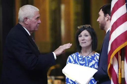 Mississippi Senate Medicaid Committee Chairman Sen. Kevin Blackwell, R-Southaven, left, confers with Mississippi House Medicaid Committee Chairman Rep. Missy McGee, R-Hattiesburg, center, and a Senate legislative attorney, Wednesday, May 1, 2024, in the hallways of the state Capitol in Jackson, Miss., moments before both chambers voted to recommit Medicaid expansion legislation. (AP Photo/Rogelio V. Solis)