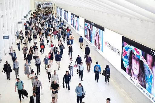 Commuters walk through a corridor in the World Trade Center Transportation Hub, June 21, 2019 in New York. Whether it’s a friend with a hot investment tip, a relative spouting off outdated directives about the way it “should” be done or a social media influencer touting a trendy financial product, money advice can be hit or miss. (AP Photo/Mark Lennihan, File)