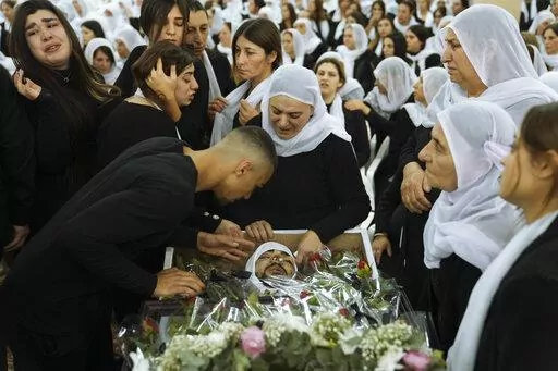 Members of the Israeli Druze minority mourn around the body of Tiran Fero, 17, during his funeral in Daliyat al-Carmel, Israel, on Nov. 24, 2022. Israel’s military says its prosecutor has filed indictments against two soldiers who allegedly hurled an explosive device at a Palestinian home in the occupied West Bank last month. The indictment announced Thursday, Dec. 29, said the two soldiers acted out of revenge for the kidnapping of the body of an Israeli schoolboy in the flashpoint West Bank 