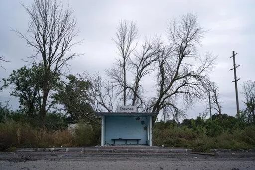 A bus stop damaged from shrapnel is seen on the road at the entrance of the freed village of Hrakove, Ukraine, Tuesday, Sept. 13, 2022. Russian troops occupied this small village southeast of Ukraine’s second largest city of Kharkiv for six months before suddenly abandoning it around Sept. 9 as Ukrainian forces advanced in a lightning-swift counteroffensive that swept southward. (AP Photo/Leo Correa)
