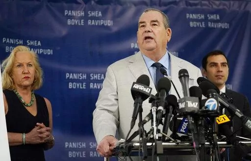 Randi McGinn, from left, Brian Panish and Jesse Creed, attorneys for the family of the late cinematographer Halyna Hutchins, take part in a news conference, Tuesday, Feb. 15, 2022, in Los Angeles. The family is suing Alec Baldwin and the movie producers of "Rust" for wrongful death, the attorneys said Tuesday. (AP Photo/Chris Pizzello)