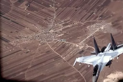 In this image from video released by the U.S. Air Force, a Russian Su-35 flies near a U.S. Air Force MQ-9 Reaper drone on July 5, 2023, over Syria. U.S. officials say that a Russian fighter jet flew very close to a manned U.S. surveillance aircraft over Syria Sunday, July 16, forcing it to go through the turbulent wake and putting the lives of the four-person American crew in danger.(U.S. Air Force via AP)