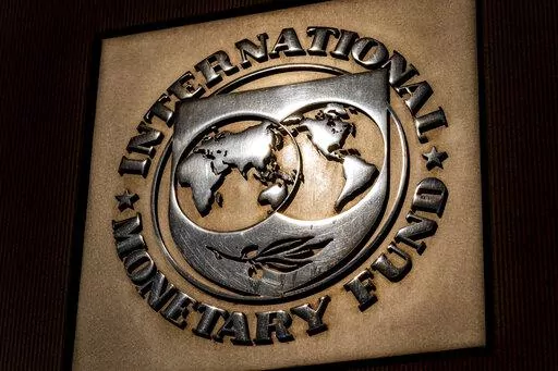 The logo of the International Monetary Fund is visible on their building, April 5, 2021, in Washington. The IMF is facing pressure to eliminate, or at least, reevaluate how it imposes fees on loans it disperses to needy countries like war-torn Ukraine — which is one of the fund's biggest borrowers. (AP Photo/Andrew Harnik)