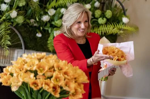 First lady Jill Biden holds a bouquet of the newest tulip named "Jill Biden" in a ceremony formally naming the flower in honor of the first lady during Dutch Tulip Days at the Embassy of the Kingdom of the Netherlands, Wednesday, April 5, 2023, in Washington. (AP Photo/Andrew Harnik)