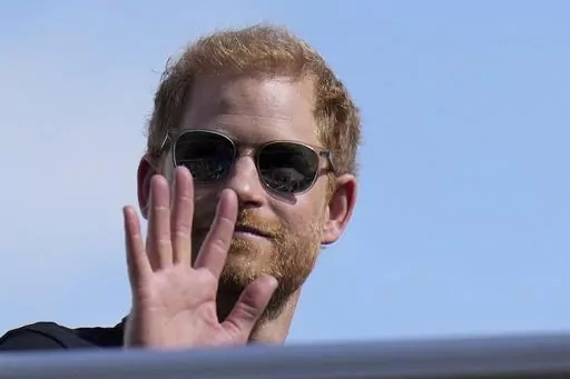 Britain's Prince Harry, The Duke of Sussex, waves during the Formula One U.S. Grand Prix auto race at Circuit of the Americas, on Oct. 22, 2023, in Austin, Texas. Prince Harry dropped his libel lawsuit Friday Jan. 19, 2024 against the publisher of the Daily Mail tabloid following a ruling in which a judge cast doubt on his case. (AP Photo/Nick Didlick, File)