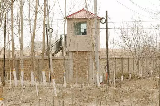 A security guard watches from a tower around a detention facility in Yarkent County in northwestern China's Xinjiang Uyghur Autonomous Region on March 21, 2021. As world leaders gather in New York at the annual U.N. General Assembly, rising superpower China is also focusing on another United Nations body that is meeting across the Atlantic Ocean in Geneva.  (AP Photo/Ng Han Guan, File)