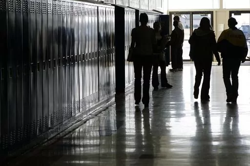Students walk down a hallway at a high school in Iowa on Tuesday, Dec. 19, 2006. In 2024, bills in the Iowa, Kentucky, Missouri and West Virginia legislatures would require public school students to watch a fetal development video similar to one created by an anti-abortion group. The proposed legislation mirrors a law passed in North Dakota last year. (Scott Morgan/The Hawk Eye via AP)