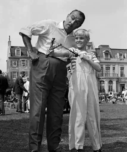 Actor Jay North, in character as Dennis the Menace, shows his ever-present slingshot to show co-star Gale Gordon, on set in Hollywood, March 29, 1962. (AP Photo/David F. Smith, File)
