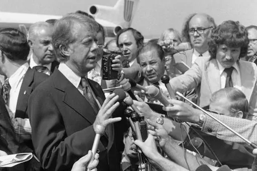Democratic presidential nominee Jimmy Carter speaks to reporters on his arrival at Hobby International Airport in Houston on Friday, Sept. 24, 1976. He explained how his remarks in a Playboy magazine interview about the late President Lyndon Johnson were misinterpreted, and that he did not mean to put Johnson and Richard Nixon in the same class. (AP Photo/Jack Thornell, File)