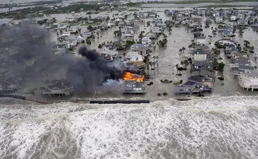 Fire destroys homes along the beach on Galveston Island, Texas, as Hurricane Ike approaches, Sept. 12, 2008. Hurricanes beginning with the letter "I" have been among the most destructive to strike the United States, moreso than any other letter of the alphabet. Idalia is on a path to strike Florida's Gulf Coast as a major hurricane to join the long list of catastrophic examples. (AP Photo/David J. Phillip, File)