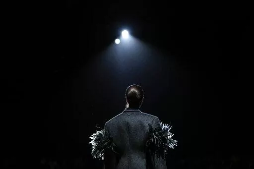 A model wears a creation as part of the Prada Fall/Winter 2022-2023 fashion collection, unveiled during the Fashion Week in Milan, Italy, Thursday, Feb. 24, 2022. (AP Photo/Luca Bruno)