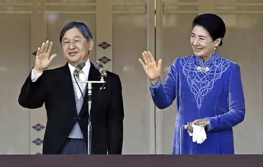 Japanese Emperor Naruhito, left, accompanied by Empress Masako, right, waves to well-wishers from the balcony of the Imperial Palace in Tokyo on his 65th birthday, Sunday, Feb. 23, 2025. (Kyodo News via AP)