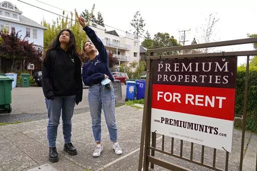 University of California, Berkeley freshmen Sanaa Sodhi, right, and Cheryl Tugade look for apartments in Berkeley, Calif., Tuesday, March 29, 2022. Millions of college students in the U.S. are trying to find an affordable place to live as rents surge nationally, affecting seniors, young families and students alike. Sodhi is looking for an apartment to rent with three friends next fall, away from the dorms but still close to classes and activities on campus. They've budgeted at least $5,200 for a