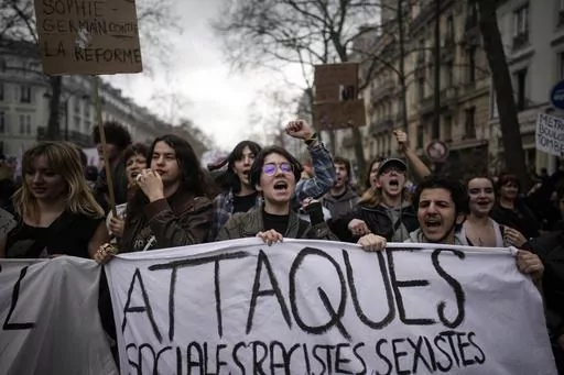 Protesters march during a rally in Paris, on March 23, 2023. French President Emmanuel Macron has ignited a firestorm of anger with unpopular pension reforms that he rammed through parliament. Young people, some of them first-time demonstrators, are joining protests against him. Violence is also picking up. (AP Photo/Christophe Ena, File)