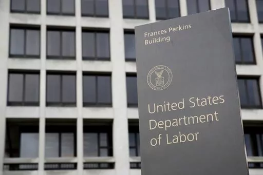 A sign stands outside the U.S. Department of Labor's headquarters, May 6, 2020, in Washington. The U.S. Department of Labor’s Occupational Safety and Health Administration found numerous safety violations in its investigation of the July 2023 workplace accident that caused the death of Duvan Pérez, a Guatemalan teenager who had been a contract worker at the Mar-Jac Poultry plant in Hattiesburg, Miss., the agency said in a news release on Tuesday, Jan. 16, 2024. (AP Photo/Patrick Semansky, Fil